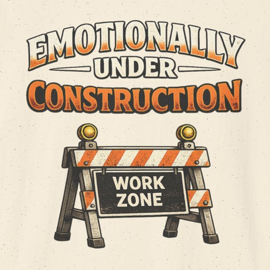 Beige t-shirt with 'Emotionally Under Construction' graphic and construction zone sign on a white background