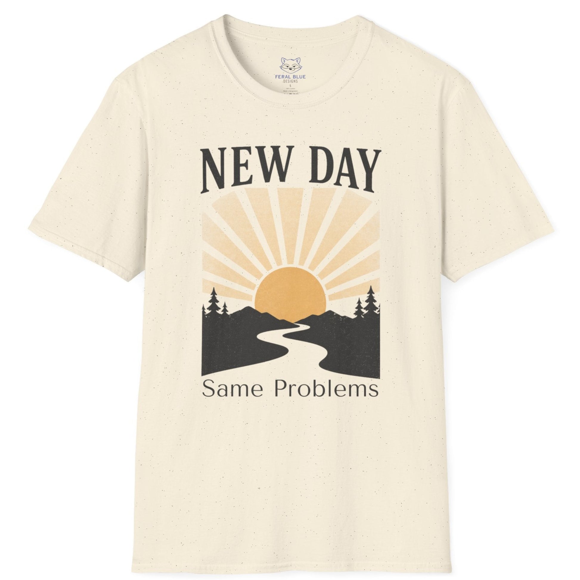 Beige t-shirt with a graphic design of a sun rising over a road flanked by trees and text 'New Day, Same Problems' on a white background.