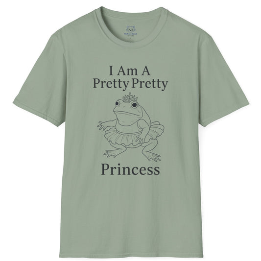 A sage green t-shirt with " I am a pretty pretty princess" black text and a black line drawing of a ballerina princess bullfrog. Princess frog wearing a tutu and tiara.