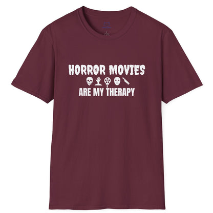 Maroon t-shirt with white text "Horror Movies are my Therapy" and mini horror icon graphics: dripping skull, hand reaching out of ground, dripping film reel, mask, dripping knife.