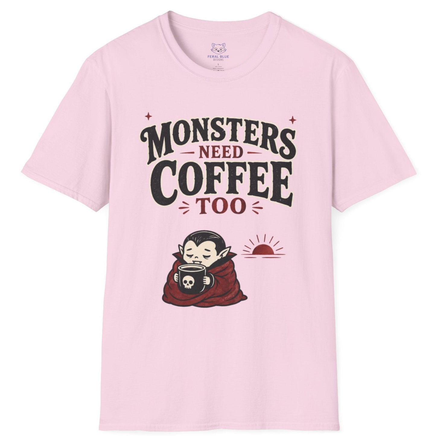 Pink t-shirt with 'Monsters Need Coffee Too' graphic on a white background