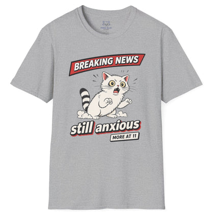 Gray t-shirt with a graphic of a raccoon and text 'Breaking News: Still Anxious' on a white background
