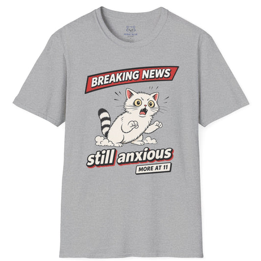 Gray t-shirt with a graphic of a raccoon and text 'Breaking News: Still Anxious' on a white background