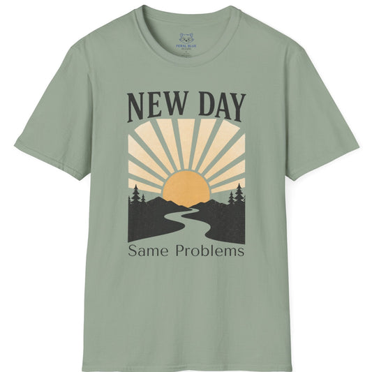 Sage green t-shirt with a graphic design and text 'New Day Same Problems' on a white background