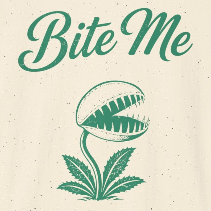 An off-white short-sleeve t-shirt with a green graphic print featuring the text 'Bite Me' above a stylized Venus flytrap illustration, shown on a plain white background.