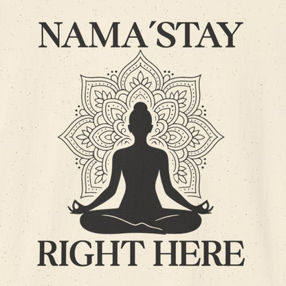 Beige t-shirt with a black silhouette of a person in meditation and text 'NAMA'STAY RIGHT HERE' 