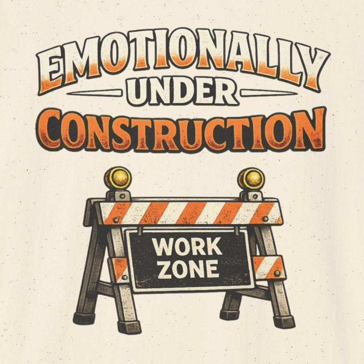 Beige t-shirt with 'Emotionally Under Construction' graphic and construction zone sign on a white background