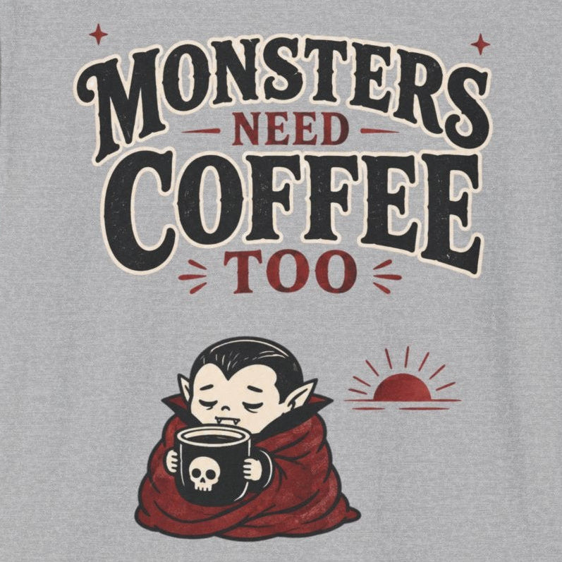 Gray t-shirt with 'Monsters Need Coffee Too' graphic design on a white background