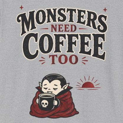 Gray t-shirt with 'Monsters Need Coffee Too' graphic design on a white background